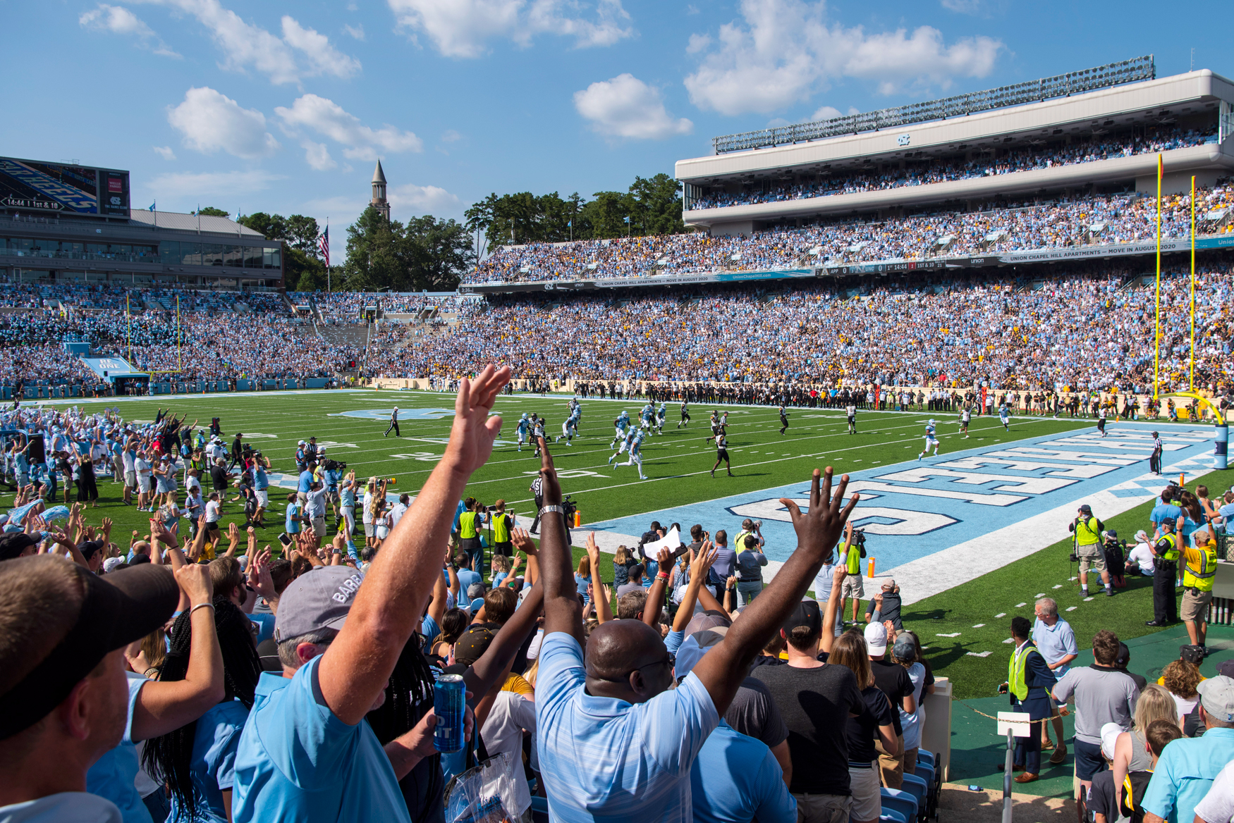The crowd cheers at a football game at The University of North Carolina at Chapel Hill