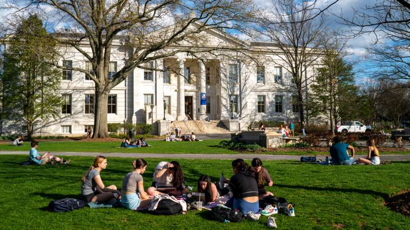 University students sit between classes on a campus lawn April 12, 2022 in Washington, DC