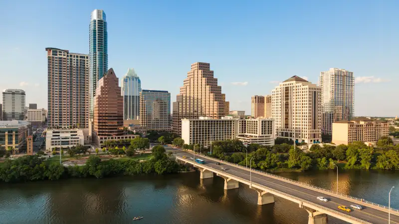 Texas skyline including Congress Avenue bridge over Ladybird Lake, Austin