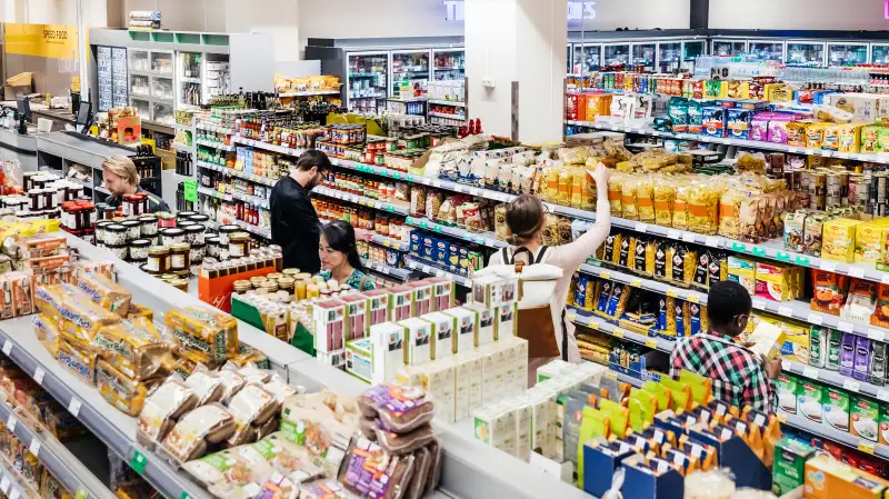 Photo of a grocery store full of people buying groceries