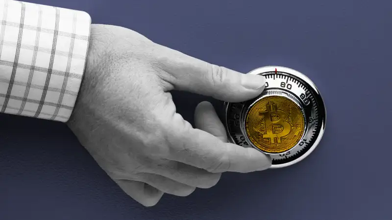 Hand turning a safe lock with a crypto coin emblazoned on the dial.