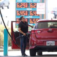 A customer pumps gas into their car at a gas station on May 18, 2022 in Petaluma, California