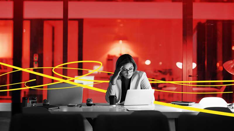Photo Illustration of a frustrated young woman working late in an empty office