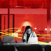 Photo Illustration of a frustrated young woman working late in an empty office