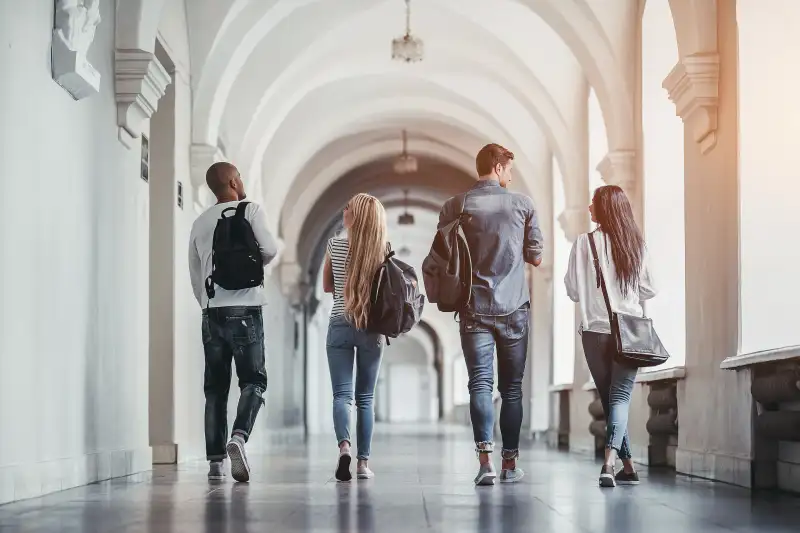 Multiracial,Students,Are,Walking,In,University,Hall,During,Break,And