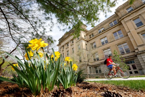 Student rides his bike at Iowa State University campus