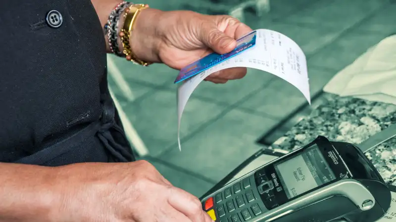 Person rings up a credit card for a purchase