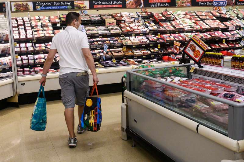A person shops in the meat department at a supermarket in Washington, DC
