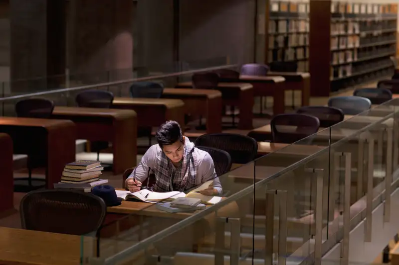 Student working in library at night