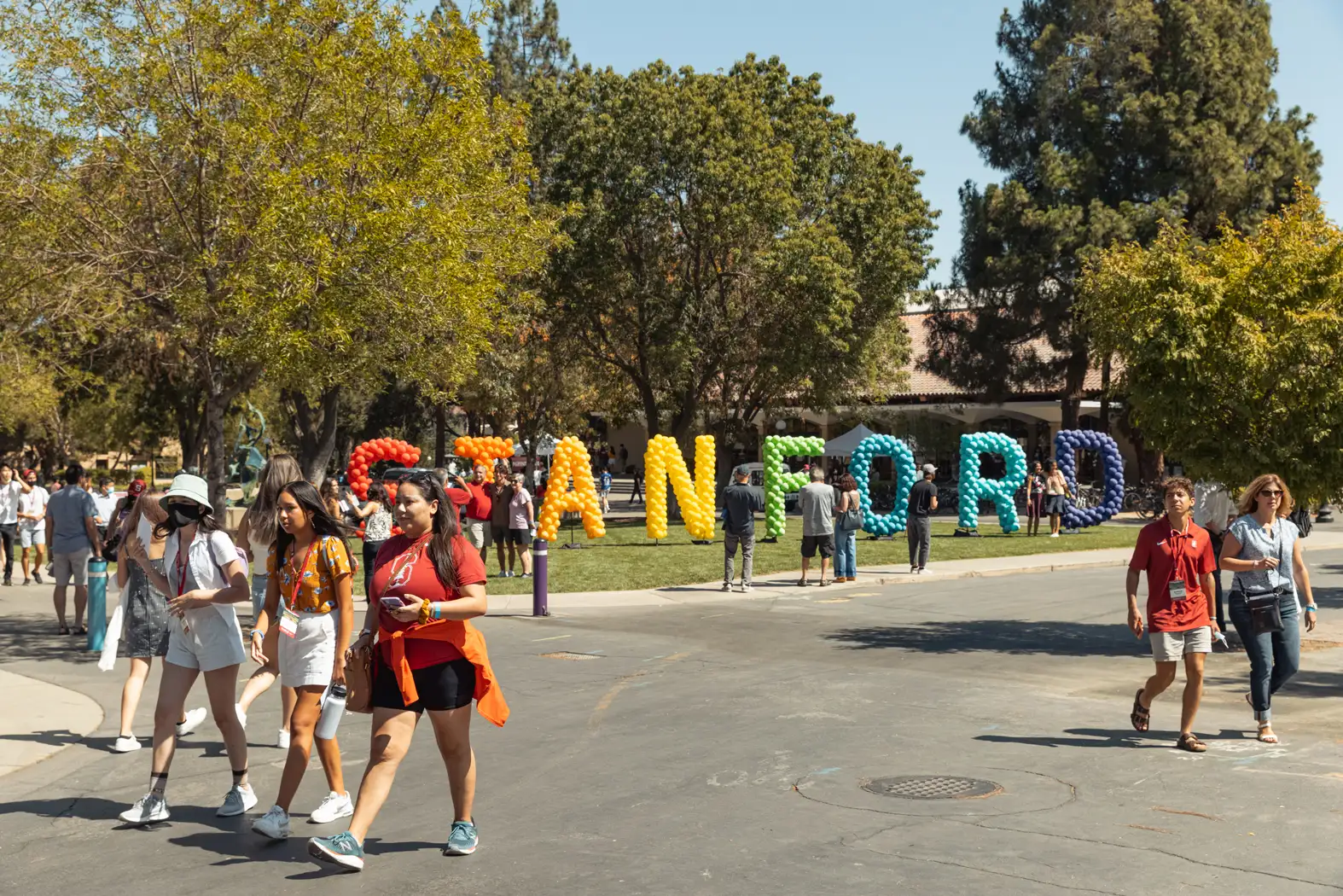 Students walk on the Stanford University campus on a sunny day