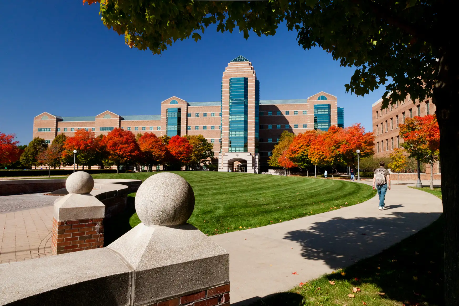 A students walks through University Illinois Urbana Champaign campus