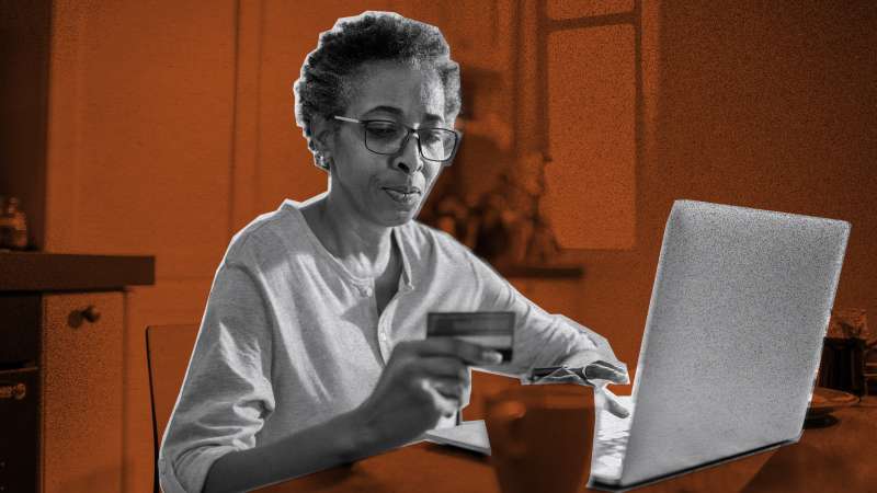 Photo of a woman using a credit card to pay online