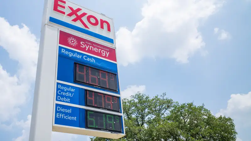 Gas prices are displayed on a gas station board