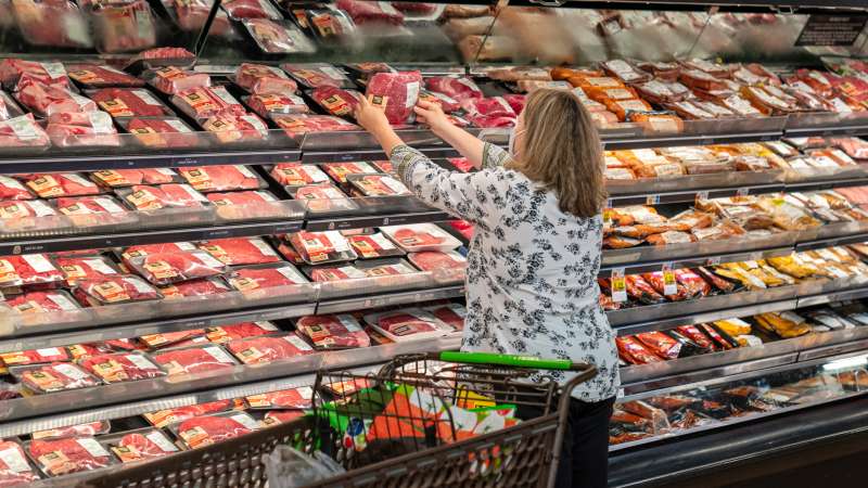 A shopper looks at a meat display at a Supermarket