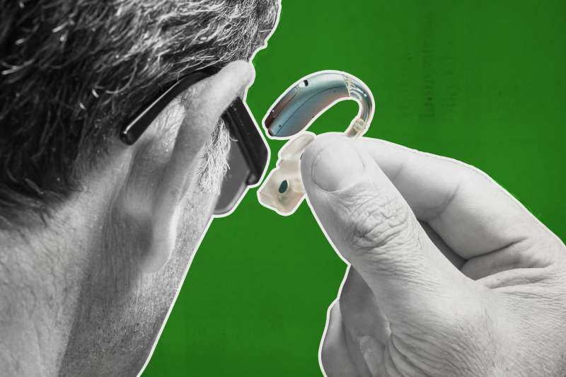 A Man Removing His Hearing Aid
