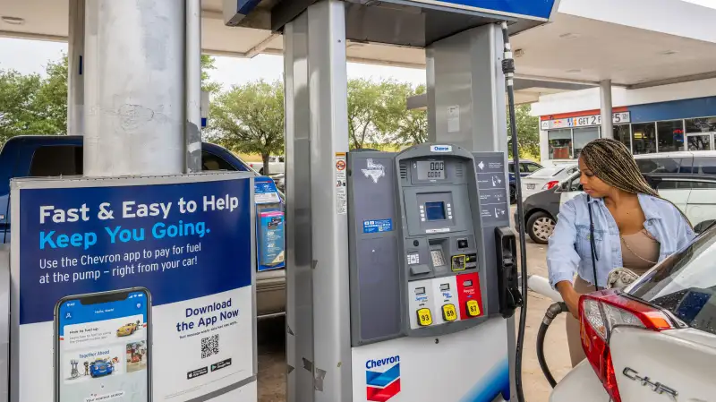 Customer prepares to pump gas at a Chevron gas station