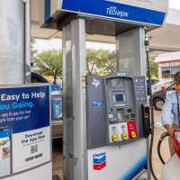 Customer prepares to pump gas at a Chevron gas station
