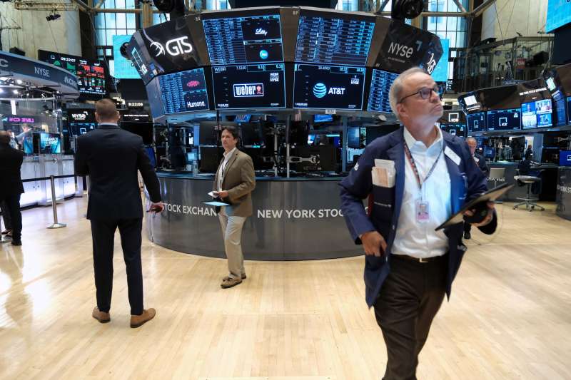 : Traders work on the floor of the New York Stock Exchange (NYSE) in New York City