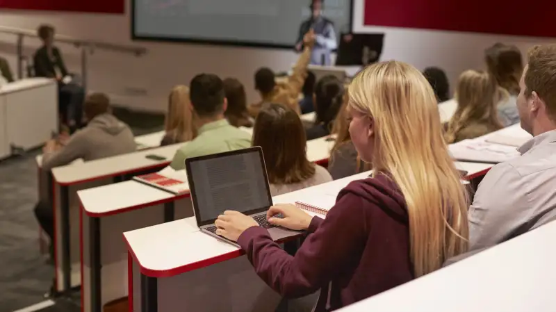 Student using their laptop during a university lecture