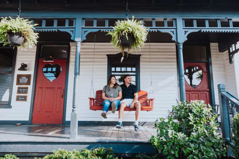 Couple sitting on a porch swing at The Coffee house in Franklin Tennessee