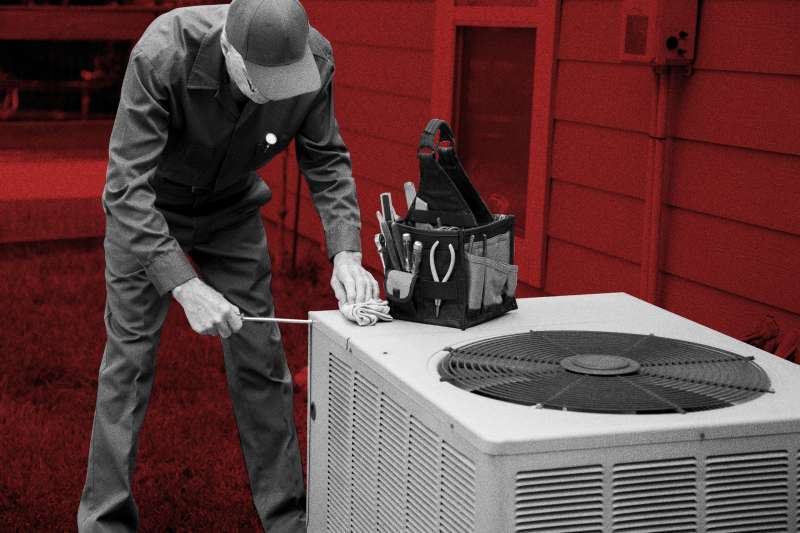 Technician repairing an air conditioner system