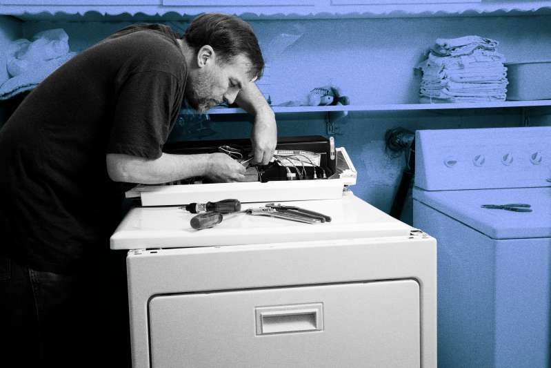 Technician repairing a dryer