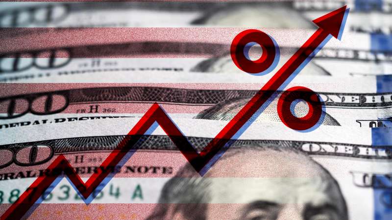 Photo illustration of some dollar bills with stripes and a percentage rate hike graph superimposed on top