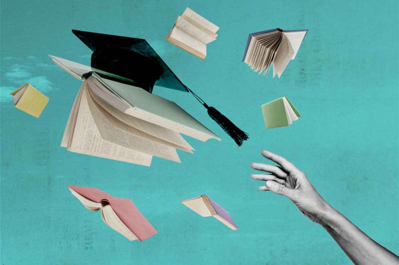 Hand Reaching Out To Flying Book. One Of the Books Has A Graduation Cap On It.