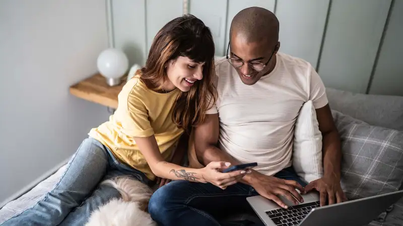 Young couple searching in their laptop computer