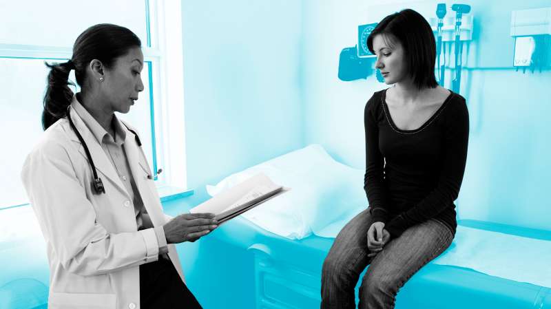 Doctor Talking with Teenage Girl