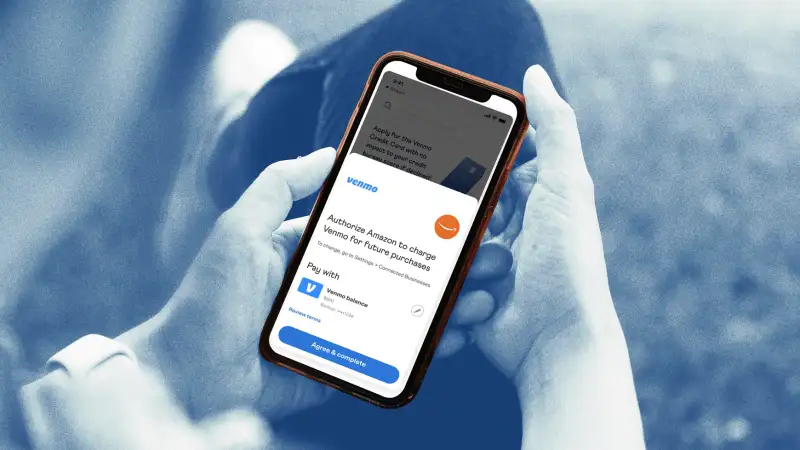 Close-up of a person using a smartphone authorizing Amazon through Venmo app