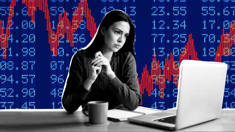 Photo collage of a concerned woman looking at her laptop with a negative stock market chart in the background