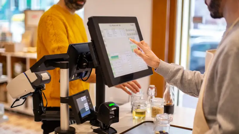 Owner using point of sale in a store