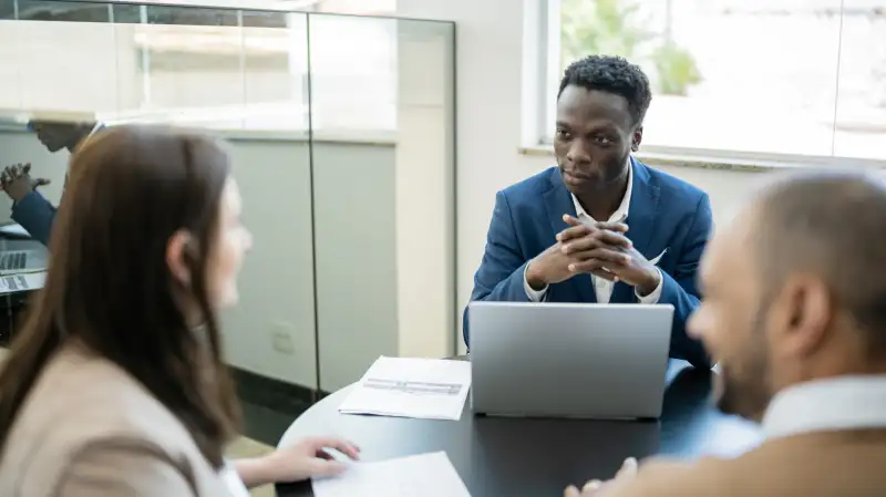 Car salesman talking to clients