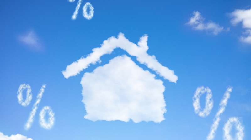 Photo illustration of house shaped cloud and percentage signs in the sky