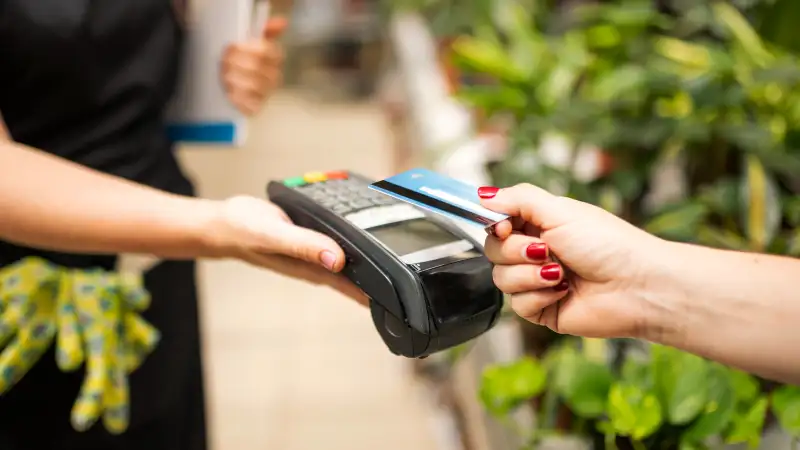 Close-up of a person paying with a credit card