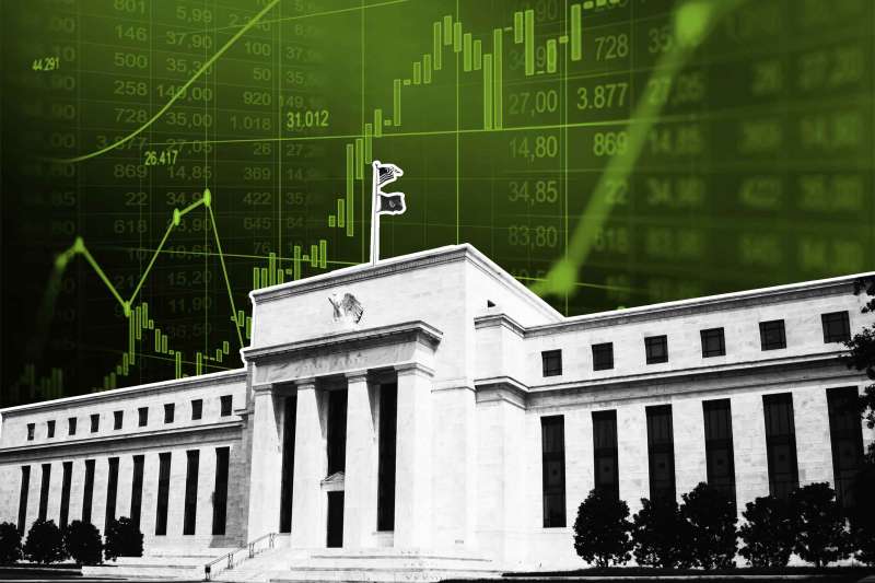 angled view of federal reserve in washington DC with stock market graph behind it