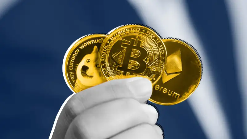 Close-up of a hand holding a dogecoin, bitcoin and ethereum coin