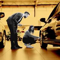 Woman inspecting a new car at car dealership