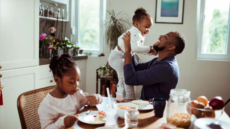 Father having breakfast with his two daughters