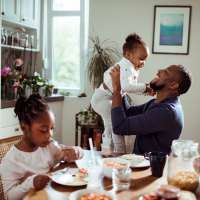 Father having breakfast with his two daughters