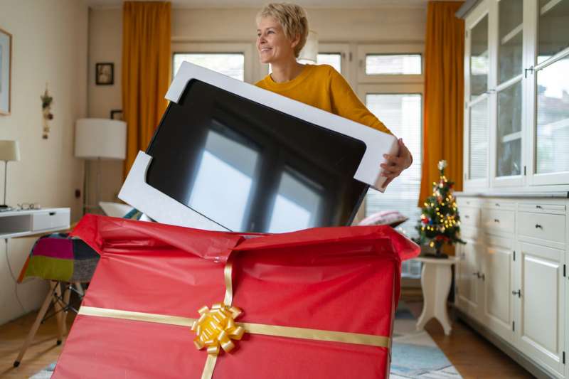 Women unwrapping her brand new TV.
