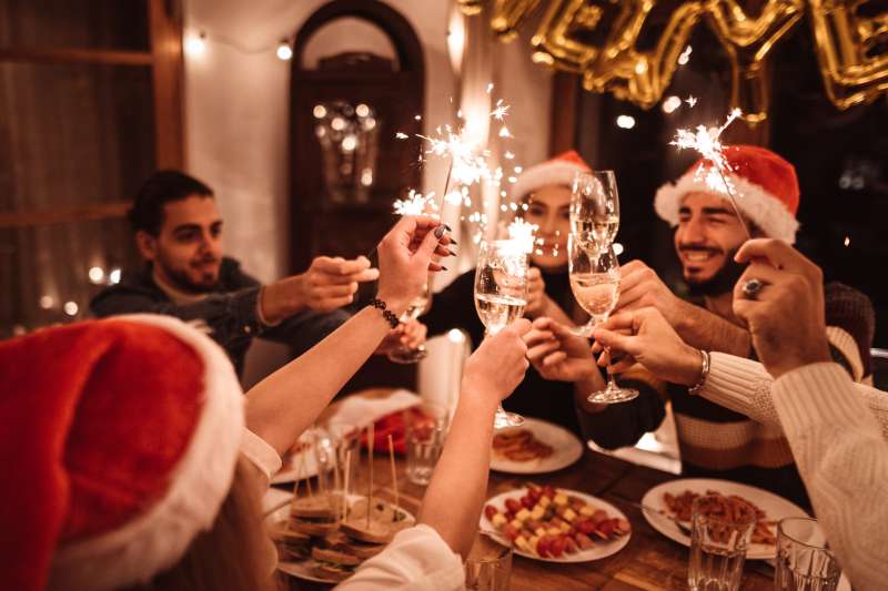 A group of people toasting at a holiday party.
