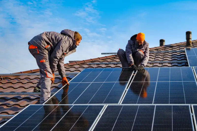 Workers installing solar cell farm power plant eco technology.