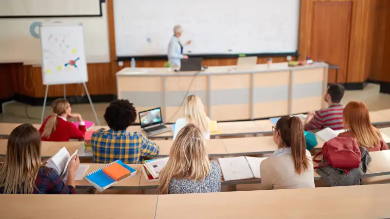 College students listening to a lecture in auditorium