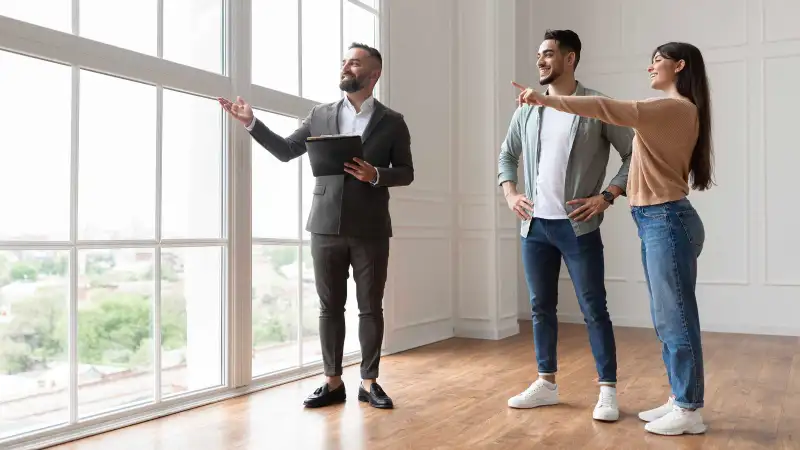 Couple inspects a new house with a realtor