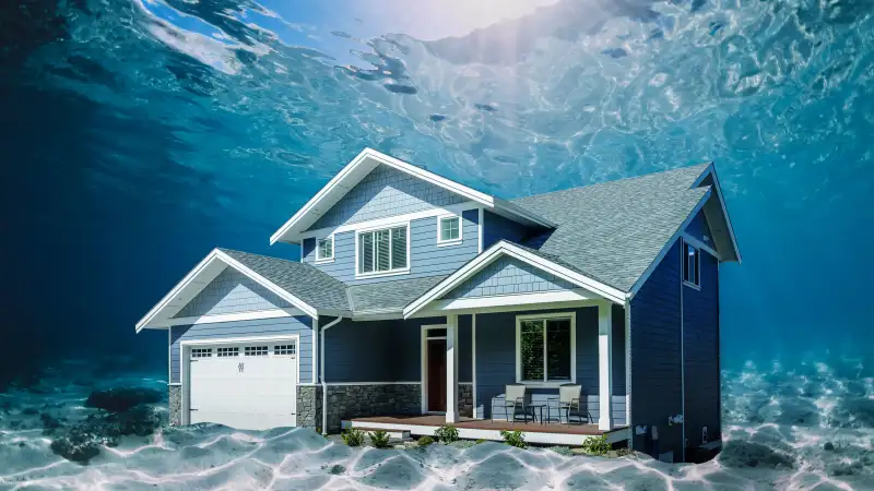 Photo collage of a suburban house underwater in the ocean