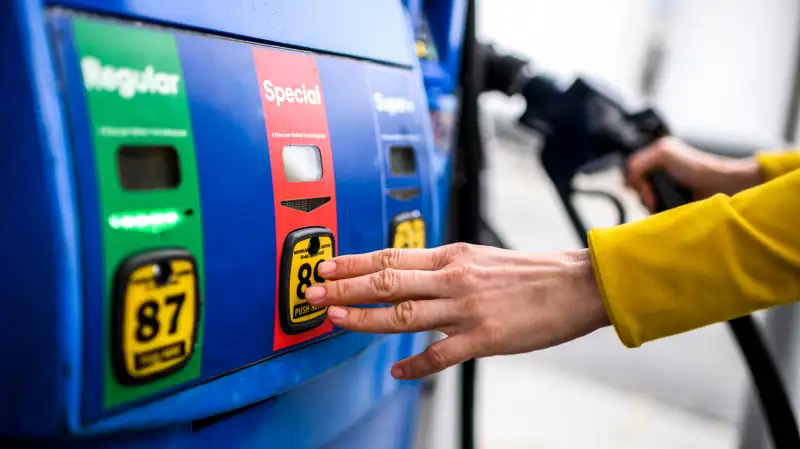 Close-up of a hand selecting the special fuel at the gas pump