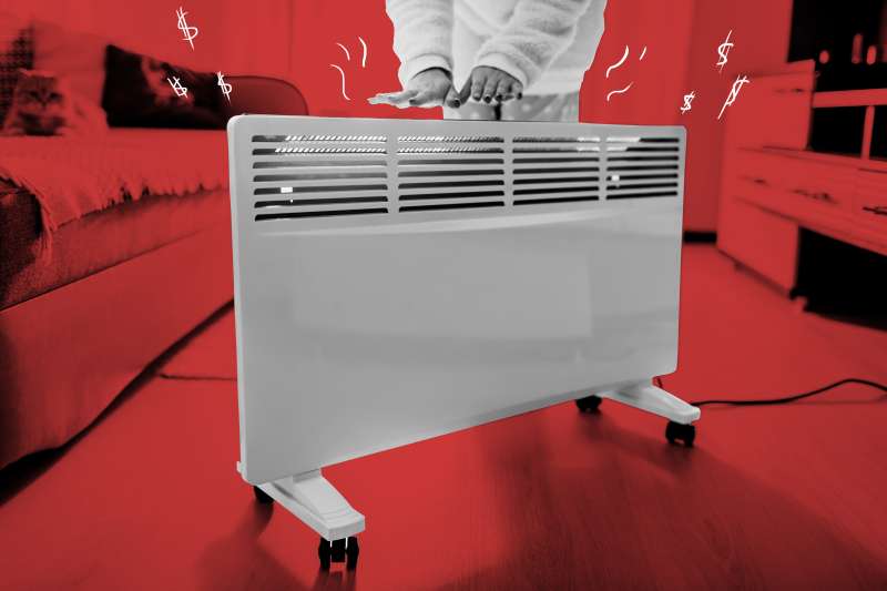 A woman warming up her hands from a space heater