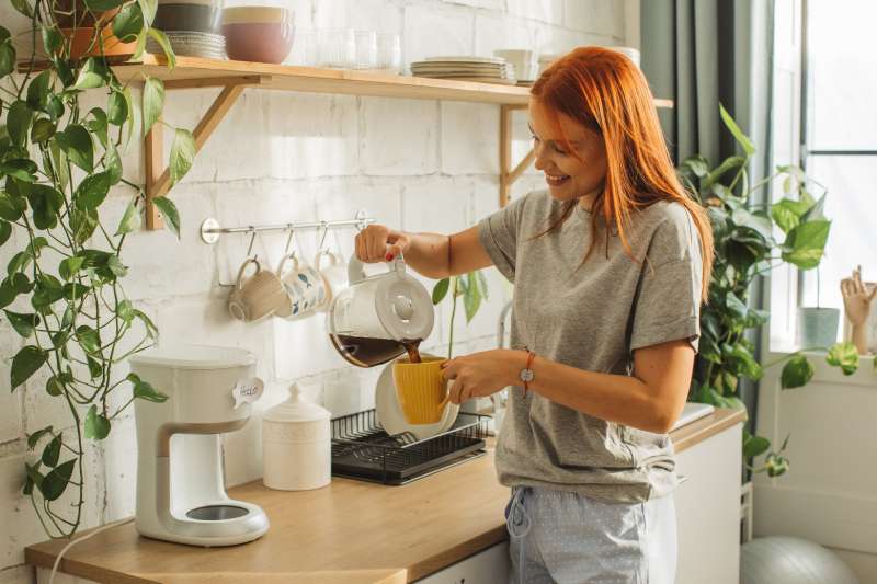 Woman pouring coffee in a mug
